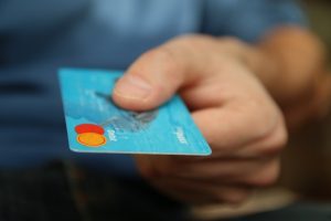 person holding a card to make a purchase 