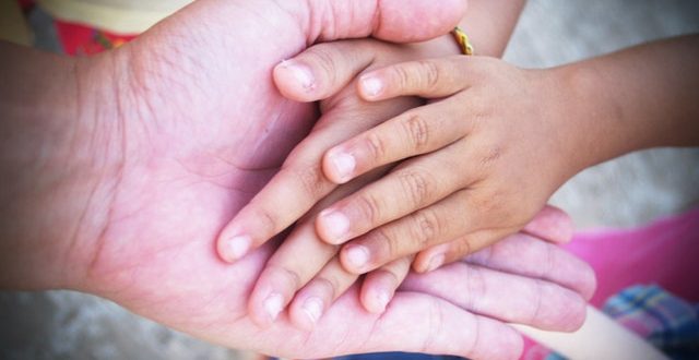 volunteer holding hands